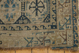 Antique Caucasian rug corner showing hard tatter and primitive geometric navy and sky blue patterns.