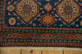 Mostly even wear to the knot heads on the geometric border of an antique Tehran rug.