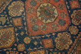 Visible knot heads and faint foundation on the geometric motifs of a fine antique Tehran rug.