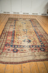 Antique Caucasian runner's yellow field with geometric motifs and time-worn terracotta and sky blue.