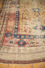 Worn antique Caucasian runner with yellow ground, terracotta, and sky blue geometric borders.