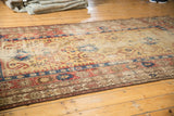 Saffron yellow ground and geometric arabesques on an antique Caucasian runner, showing wear.