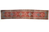 Antique Bakshaish Persian runner with linked diamond medallions on an abrashed pomegranate field.