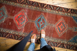 Antique Bakshaish runner with pomegranate abrashed field and alternating sky blue diamond motifs.