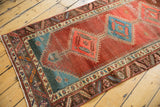 Antique Bakshaish runner detail: abrashed pomegranate field, sky blue diamond, geometric borders, and low pile.