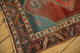 Antique Bakshaish runner corner shows low pile, visible foundation, pomegranate and blue abrash.