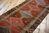 Abrashed cochineal pomegranate field of an antique Bakshaish runner, with low pile and visible wear.