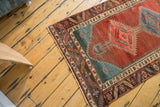Corner of antique Persian Bakshaish runner, showing low pile and intricate borders.
