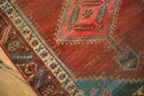 Abrashed cochineal red field detail, blush medallion corner, and intricate ivory Bakshaish border.