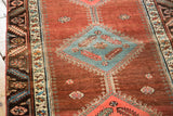 Abrashed cochineal pomegranate field and sky blue diamond motif on an antique Bakshaish runner.
