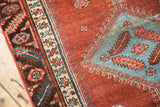Low pile abrashed cochineal pomegranate field with sky blue diamond medallion on antique Bakshaish.