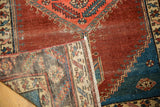 Antique Bakshaish rug: low pile, abrash on pomegranate field, fringe, and woven foundation.