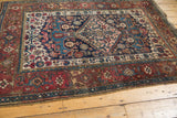 Antique Persian Kurdish Bijar rug corner with traditional red geometric borders and navy Herati field.