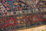 Kurdish Bijar rug corner, showcasing low pile and geometric motifs in rich red, navy, and cream.