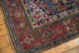 Antique Kurdish Bijar rug corner with wine red border, blue guard band, and low pile.
