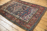 Geometric and floral layered borders, low pile, and secured fringe of an antique Bijar rug.