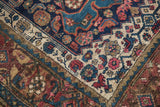 Intricate navy Herati pattern and cream floral inner border on an antique Kurdish Bijar rug.