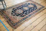 Secured end and intricate border details of the vintage Hamadan rug with low pile.