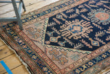 Vintage Hamadan rug corner detail, low pile, navy field with pale blush designs.
