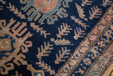 Navy blue vintage Hamadan rug, pale blush germinating plants, low pile, visible knot heads.