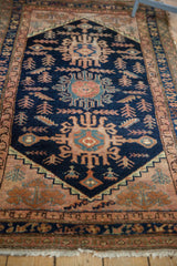 Hand-knotted Hamadan rug: navy blue field with triple medallions, tribal people and plant motifs.