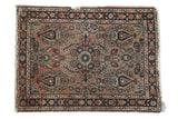 Hand-knotted vintage Lilihan rug with dusty rose floral field and navy border.