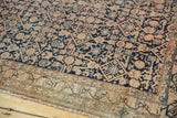 Antique Malayer rug corner, Herati pattern, navy and ivory tones, visible wear, border patch.