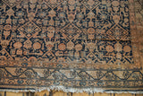 Worn lower border and secured fringe of antique Malayer runner with navy geometric pattern.