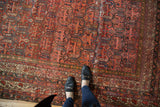 Antique Malayer carpet: intricate multi-panel design in madder red, cobalt blue, and mostly even wear.