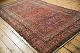 Antique Malayer carpet with intricate lattice vinery and multi-panel design in madder red and unique tones.