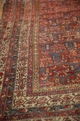 Antique Malayer carpet showcasing intricate madder red panels and subtle textural wear.