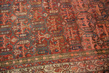 Intricate multi-panel design and lattice vinery of antique Malayer rug, madder root red and cobalt blue.