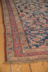 Close-up of antique Kurdish Hamadan rug's red border, navy Herati field, and even wear.