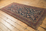 Antique Kurdish Hamadan rug corner showing secured fringe, softened Herati field, and meandering vine border.
