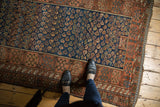 Fine antique Kurdish rug section featuring allover boteh, geometric borders, and aged side selvage.