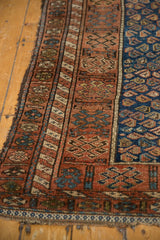 Fine antique Kurdish rug: madder red geometric border, cobalt blue field, light tatter.