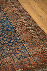 Varied cobalt blue boteh motifs and madder root red geometric border of antique Kurdish rug.