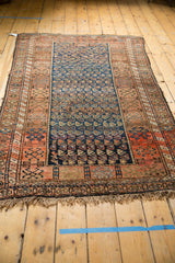Fringed bottom edge of an antique Kurdish rug with tribal geometric patterns.