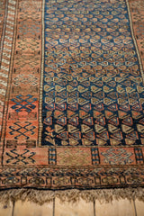 Close-up of a hand-knotted Kurdish rug's playful boteh design on a cobalt blue field.
