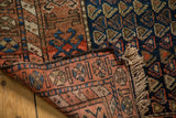 Finely hand-knotted antique Kurdish rug detail, madder red foundation, indigo blue pile, and fringe.