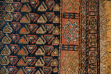 Madder root red geometric border, indigo boteh motifs, and fringe on this antique Kurdish rug.