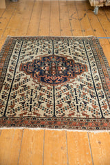 Vintage Afshar rug's lower border, terracotta and navy patterns, ivory fringe, tree of life.