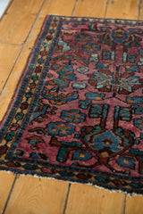 Vintage Lilihan rug's plum field, large powder blue floral motifs, and low pile texture.