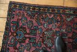 Plum, dusty gold, and powder blue floral motifs with low pile on this vintage Lilihan rug.