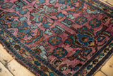 Vintage Lilihan rug with intricate plum, blue, and gold floral patterns and low pile.