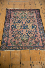 Detailed Mahi motifs, blush field, and secured end of antique Lilihan rug.