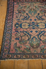 Antique Lilihan rug corner featuring blush field, blue borders, stylized florals, and visible pile wear.