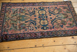Intricate dark geometric border and blush field motifs on this antique Lilihan rug, with visible wear.