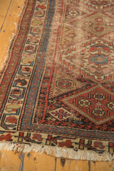 Antique Kurdish rug: rich madder root red, sky blue border with hook and latch motifs.