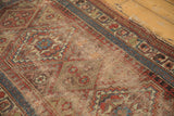 Madder red and sky blue geometric patterns on an antique Kurdish rug border and field.